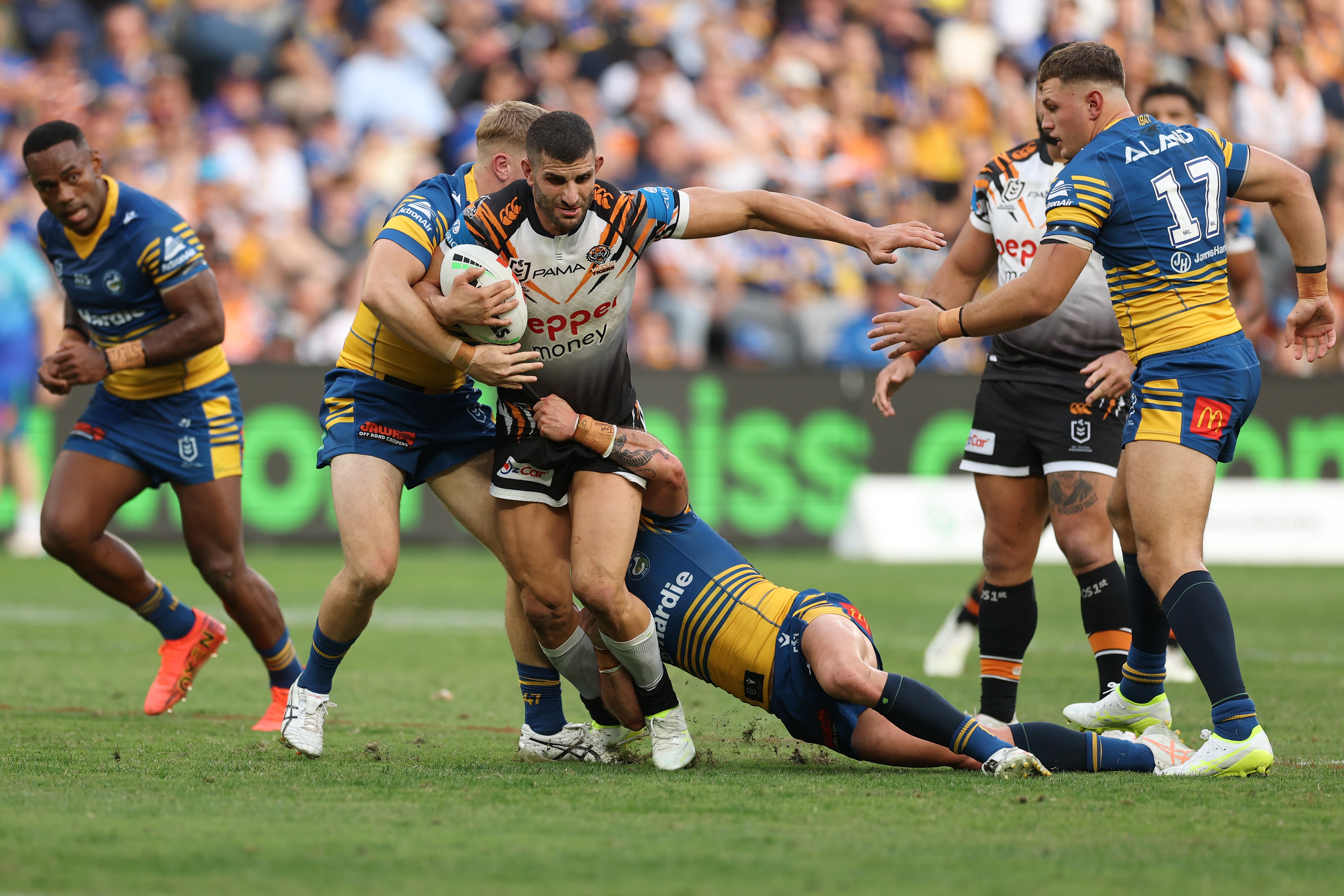 A man runs the ball during a rugby league match 