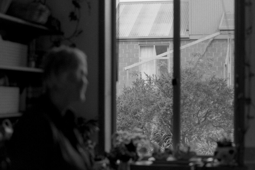 A woman looks out the window 