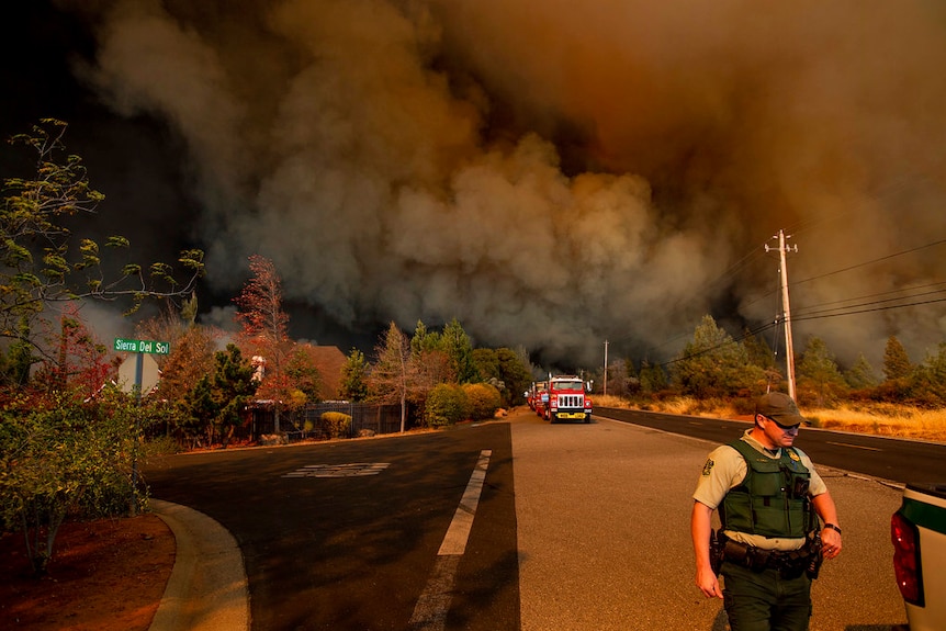 Smoke covered roads as people were forced to flee the fast-moving wildfire on foot.