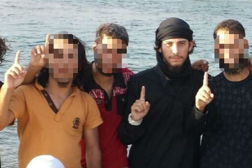 Mehmet Biber pictured with three friends in front of a waterway.