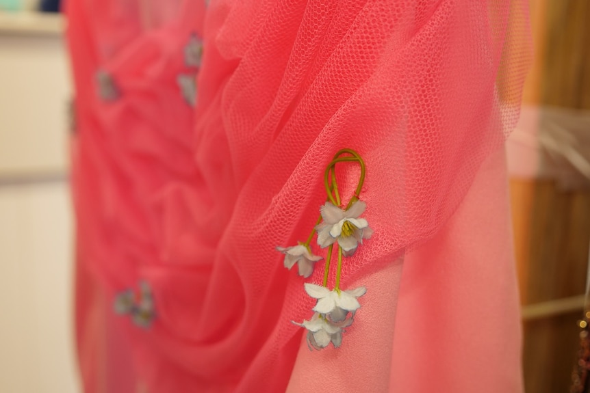 Pink dress, handmade flowers, close up.