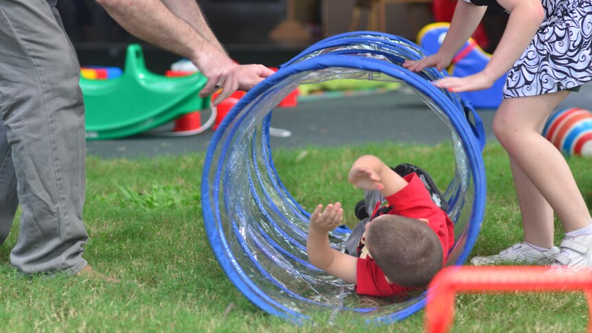 Children play with staff at the Browns Plains Early Years Centre.
