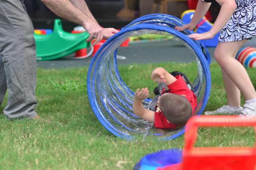 Children play with staff at the Browns Plains Early Years Centre.