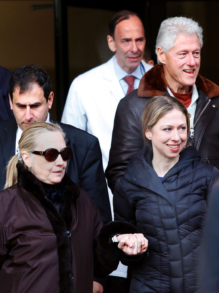 Hillary Clinton leaves the New York Presbyterian hospital with her husband Bill and daughter Chelsea.