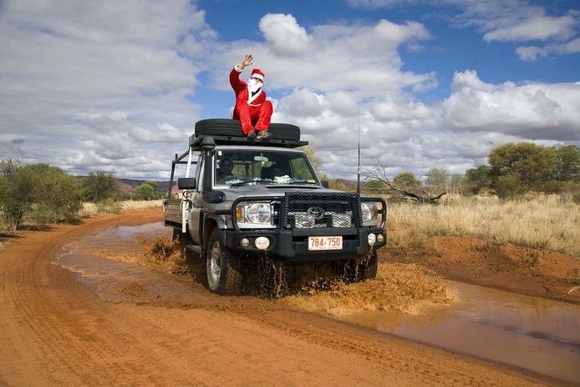 Santa, aka German chef Marco Schmidt, makes his way to the Ulpanyali Community