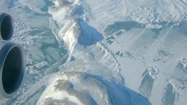 A plane flies over the Northeast Greenland Ice Stream.