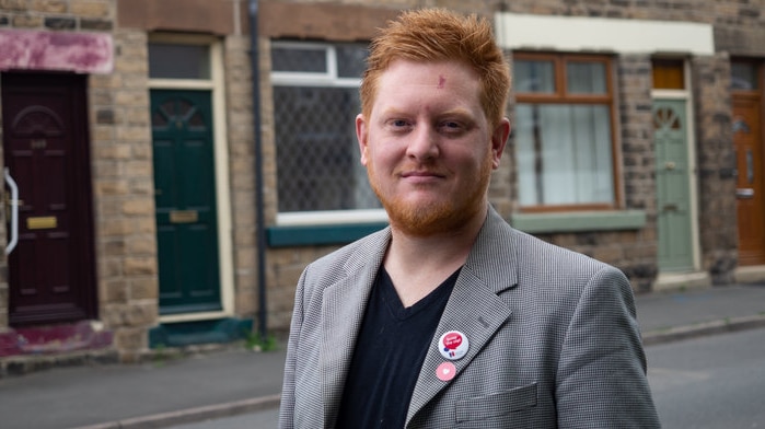 British MP Jared O'Mara stands on a street posing for a photo