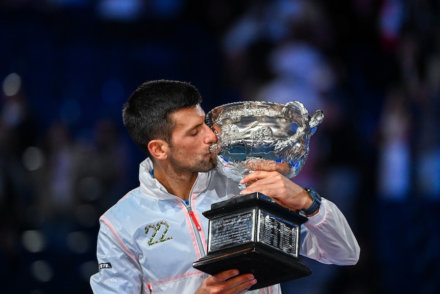 Novak Djokovic kisses the Australian Open trophy