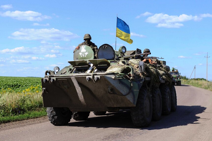 Ukrainian soldiers drive a military vehicle at a checkpoint near Slaviansk in eastern Ukraine.