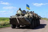 Ukrainian soldiers drive a military vehicle at a checkpoint near Slaviansk in eastern Ukraine.