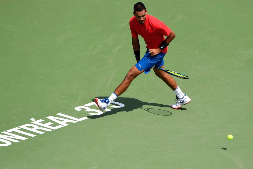 Nick Kyrgios hits a shot between his legs against Viktor Troicki during his opening win in Montreal.