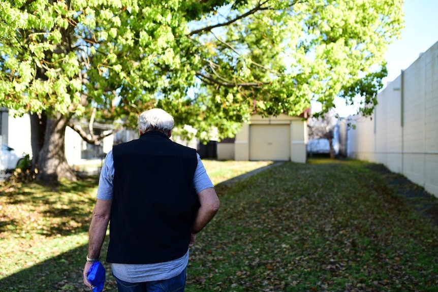 Older man walking in a park