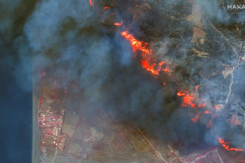 Aerial shot of the fire shows flames and smoke blanketed the island