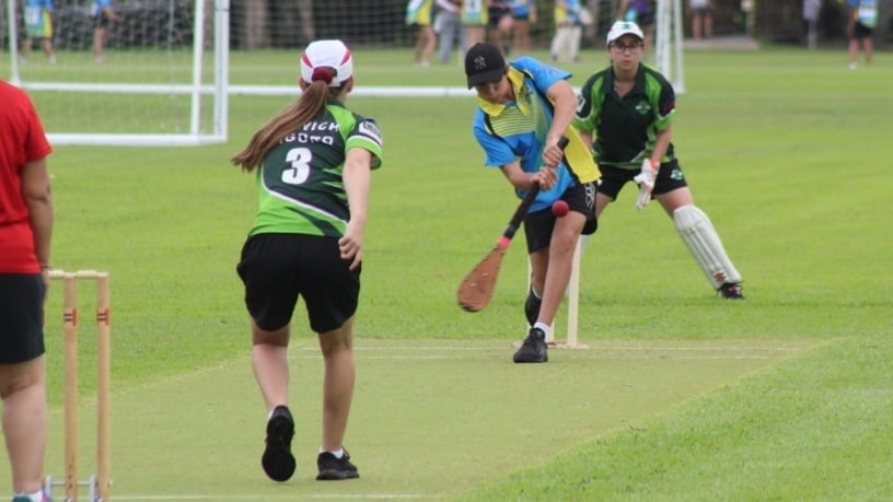Women playing cricket type game