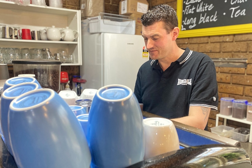 A man works in his cafe 