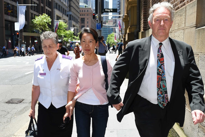 Kathy Lin, the wife of Robert Xie, leaves the NSW Supreme Court in Sydney with her husband's lawyer.