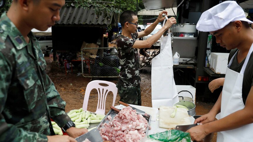 Soldiers prepare food for cooking near the Tham Luang cave complex.