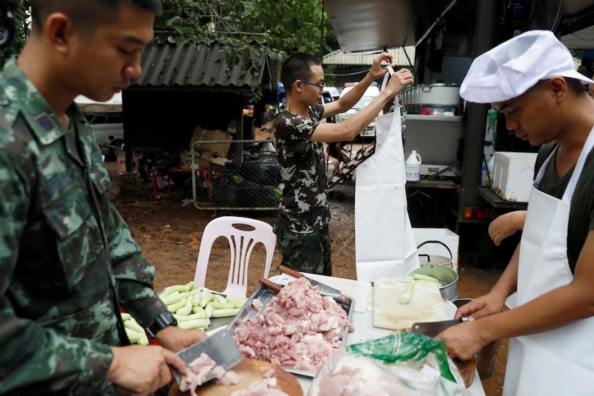 Soldiers prepare food for cooking near the Tham Luang cave complex.