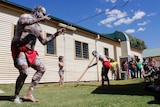 Barkinji man Christopher Quale performs a traditional dance after the repatriation at Kinchega National Park.