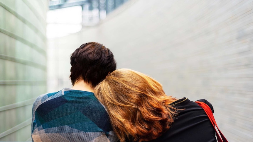 Head leaning on shoulder in support for a story about dealing with emotional labour