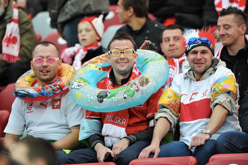 Polish fans prepared for rain at at the World Cup qualifying match between Poland and England.