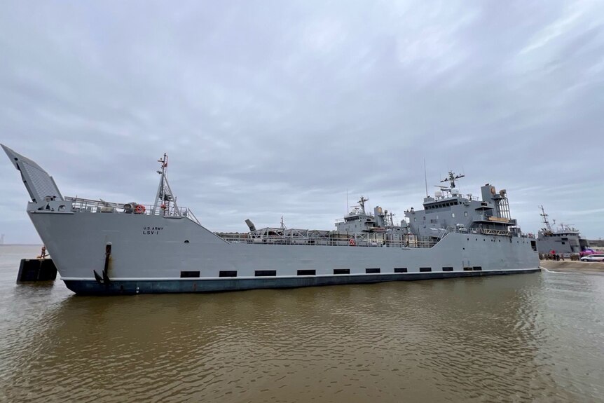 A photo of a long, grey US military ship.