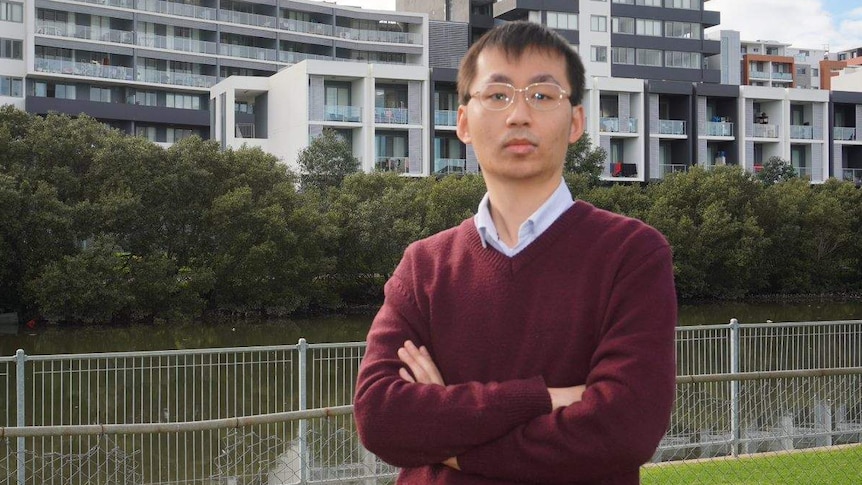 A man poses in front of units