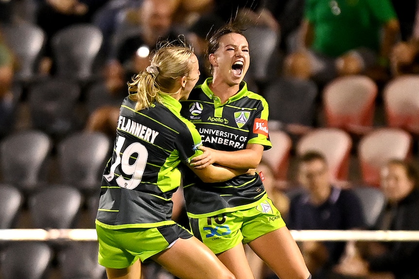 Grace Maher celebrates by hugging a teammate after scoring a goal