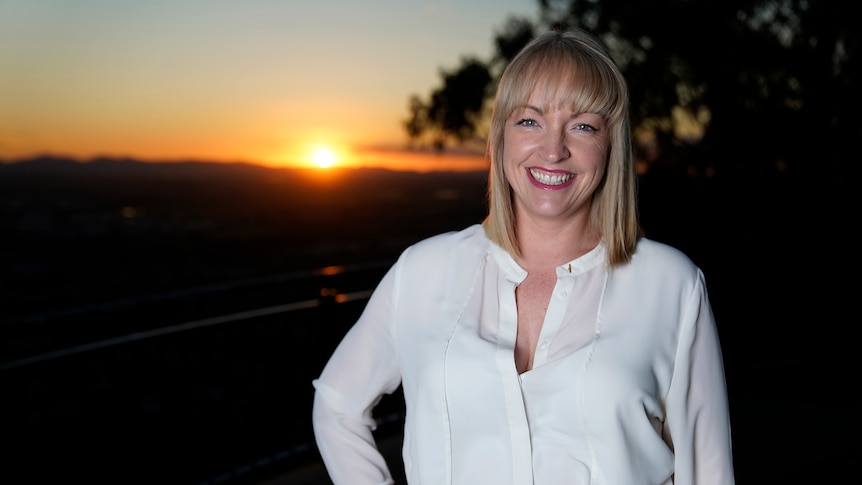 Portrait of radio presenter Anna Moulder with the sun setting in the background.