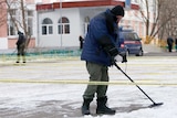 Russian security service members use mine and metal detectors outside a Moscow school