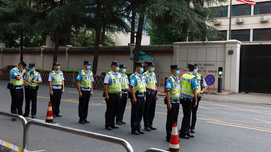 Rows of Chinese police officers line up in front of the United States Consulate.