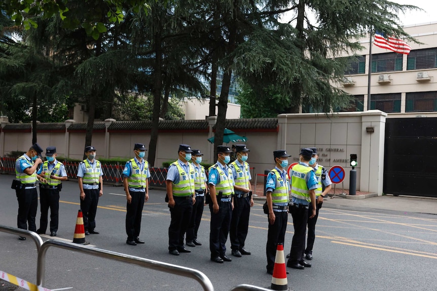 Rows of Chinese police officers line up in front of the United States Consulate.