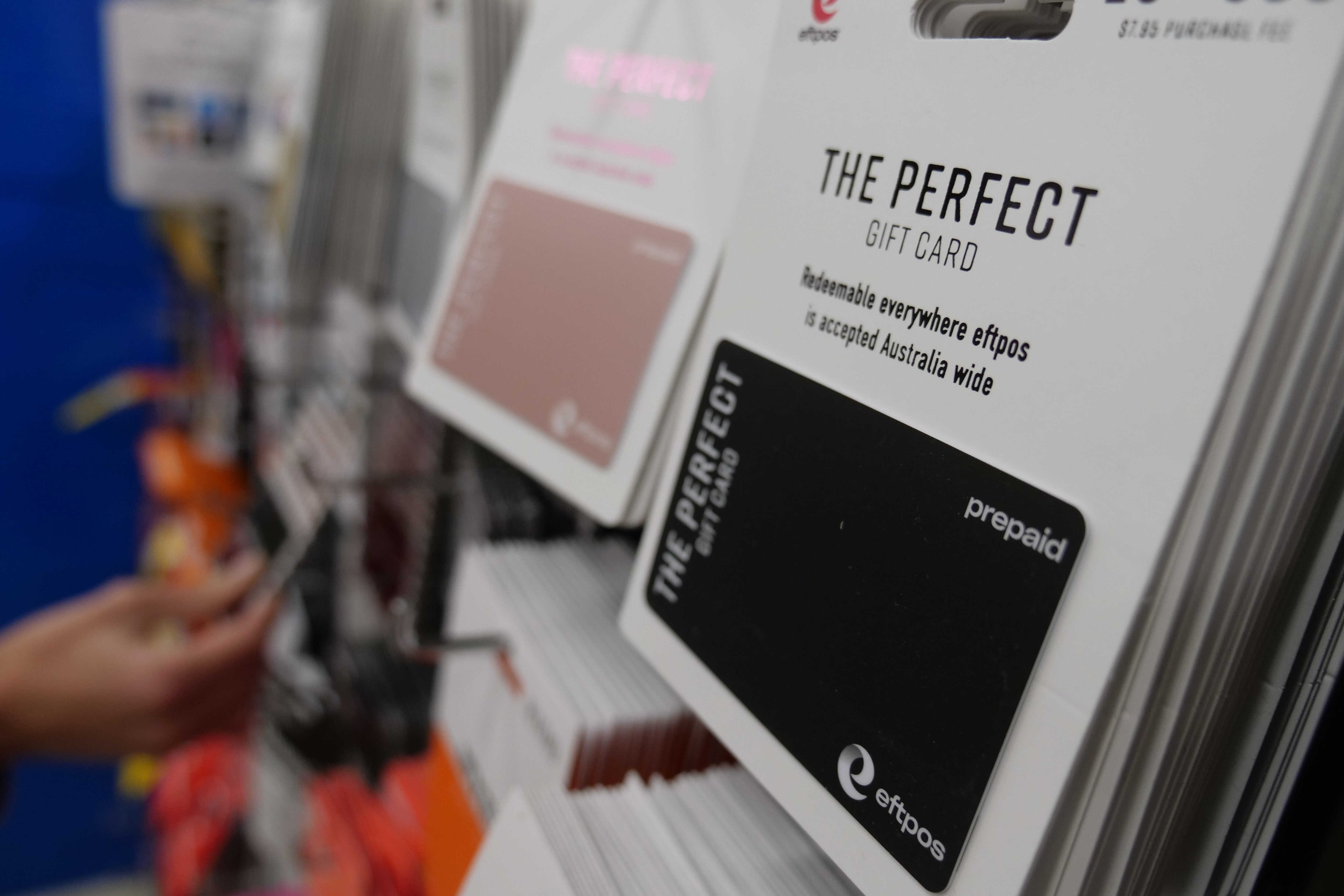 Rows of gift cards on a wall at a supermarket