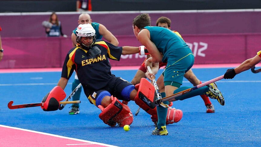 Spain's goalkeeper Francisco Cortes (L) is challenged by Australia's Simon Richard