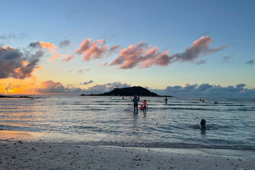 Sunset over the water on a Jeju island beach.