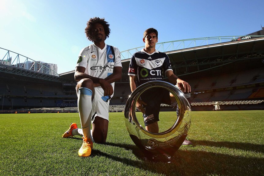 Kew Jaliens of Melbourne City FC and Guilherme Finkler of Melbourne Victory pose with the championship trophy