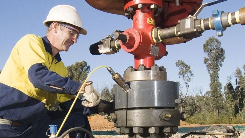 A worker fiddles with a coal seam gas drill.