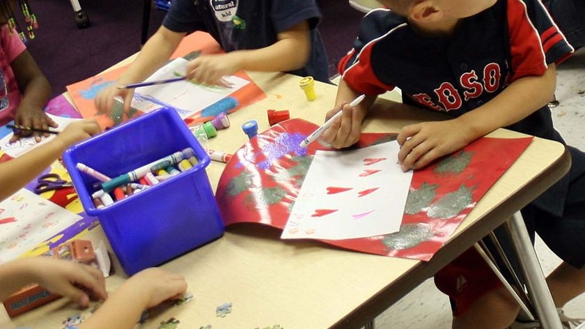 Children in kindergarten work at a table