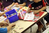 Children in a kindergarten work at a table