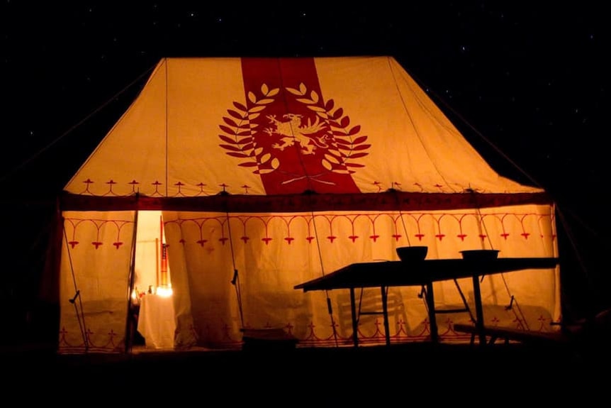 A large medieval tent with modern medieval heraldry on it. 