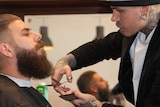Ash Weller trims Tim Hutton's beard.