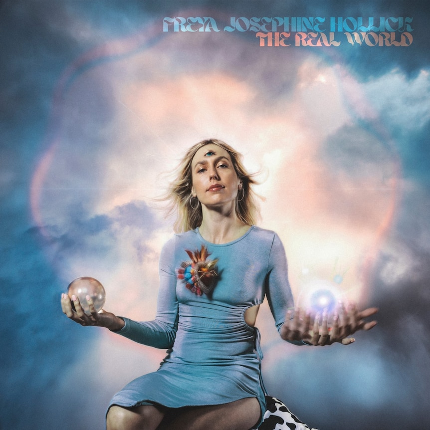 woman in blue dress with third eye holds crystal balls in each hand