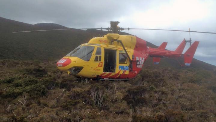 Tasmania's rescue helicopter flying over dense forest