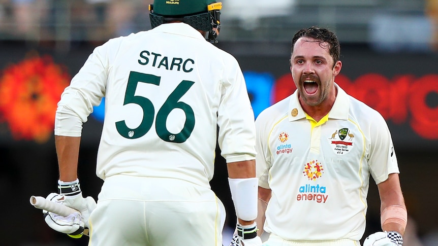 Australia batter Travis Head shouts in joy at Mitchell Starc after reaching 100 in the first Ashes Test at the Gabba.