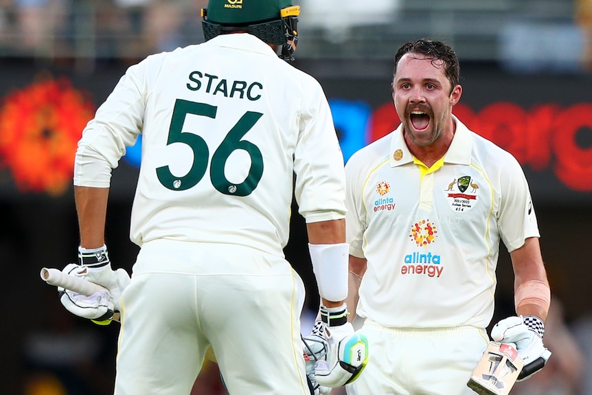 Australia batter Travis Head shouts in joy at Mitchell Starc after reaching 100 in the first Ashes Test at the Gabba.