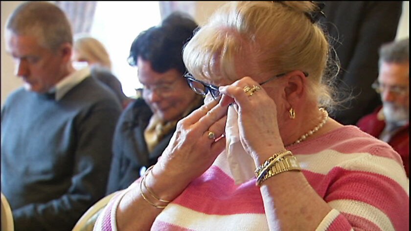Tasmanian pensioner Gloria Miller wipes away tears at a public hearing over power prices