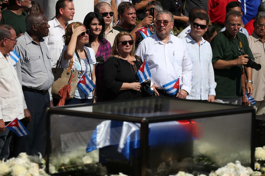Fidel Castro Diaz-Balart stands with a crowd watching his fathers ashes arrive in Santiago de Cuba