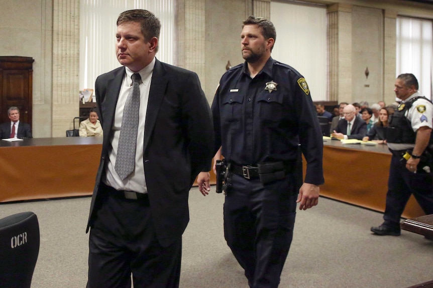 Jason Van Dyke is taken into custody by a court security guard