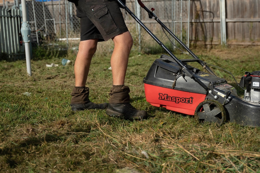 Max Heerey mowing the lawn.