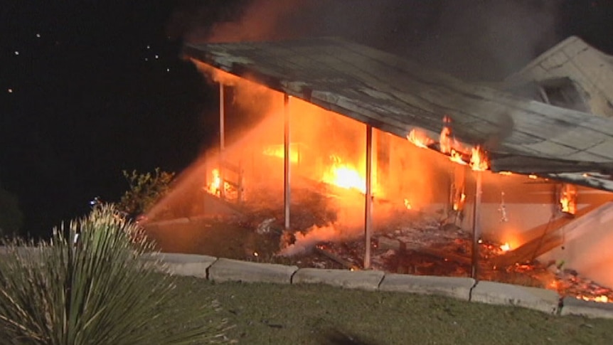 Fire engulfs a house at Tallai on Queensland's Gold Coast hinterland on November 24, 2013